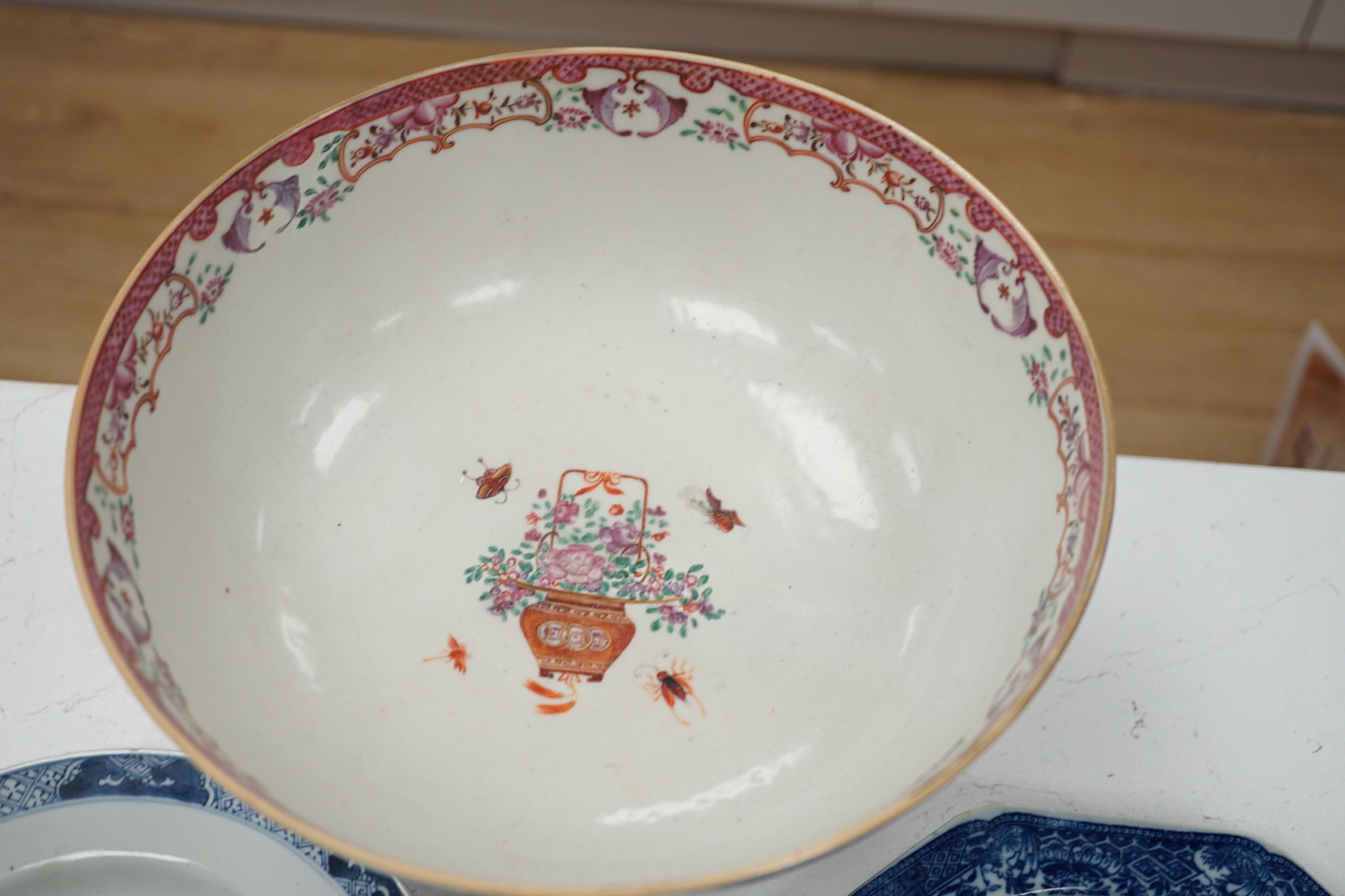 A Chinese export armorial soup plate, for the Spanish market, Qianlong period, with a Spanish coat of arms, possibly Aguado de Las Marismas, an 18th century Chinese export punch bowl on stand, a Chinese blue and white pl